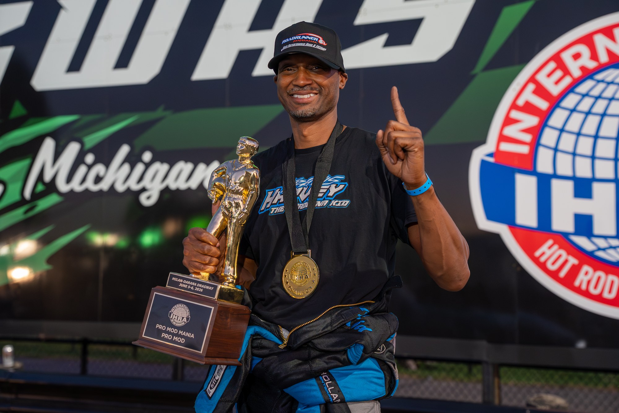 Travis Harvey hoists the IHRA Pro Mod Mania trophy at Milan Dragway.