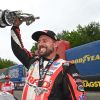 Dallas Glenn hoists the Pro Stock trophy after winning the NHRA New England Nationals at Epping.