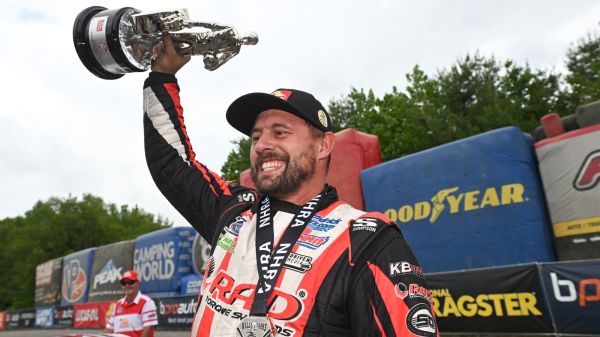 Dallas Glenn hoists the Pro Stock trophy after winning the NHRA New England Nationals at Epping.