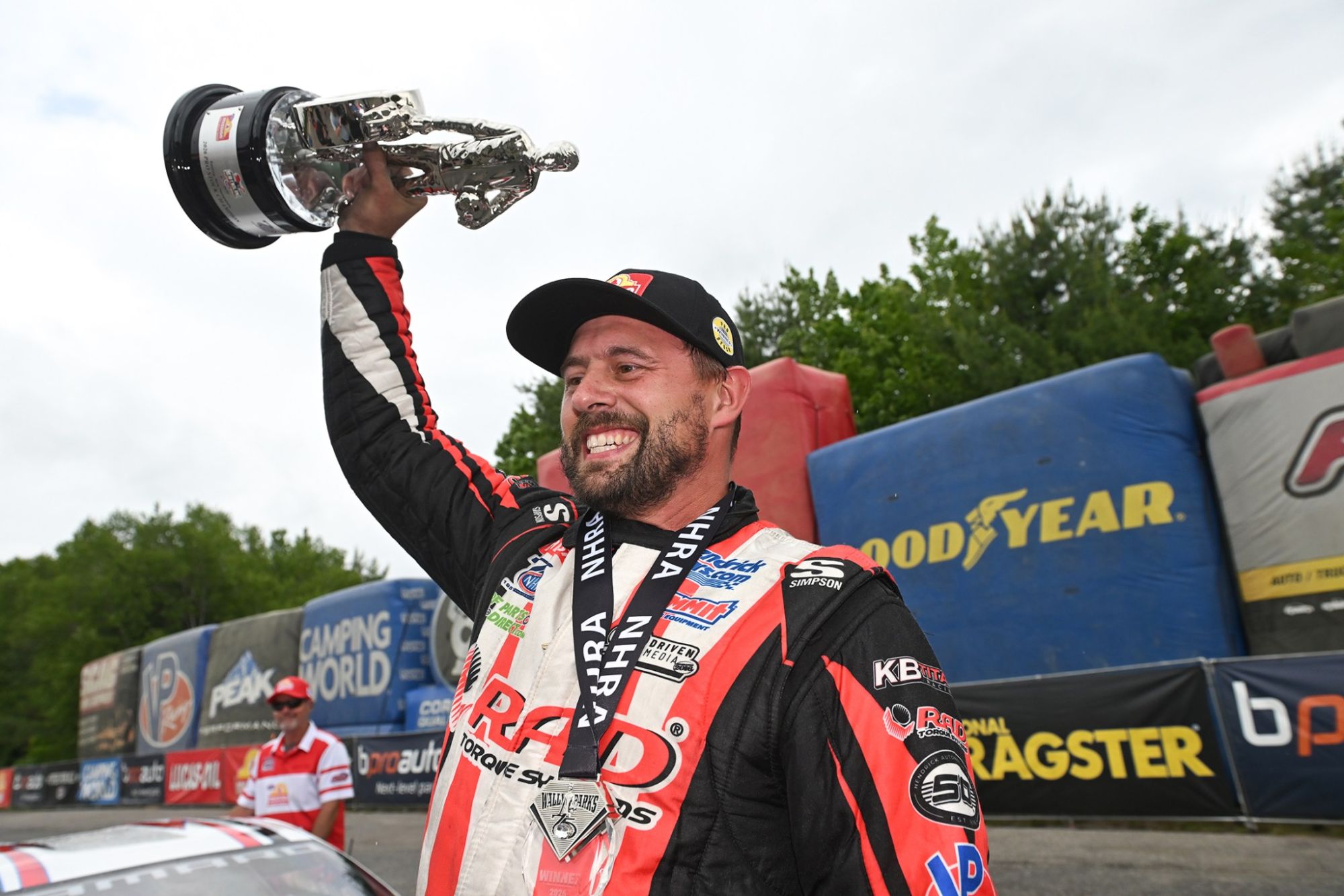 Dallas Glenn hoists the Pro Stock trophy after winning the NHRA New England Nationals at Epping.