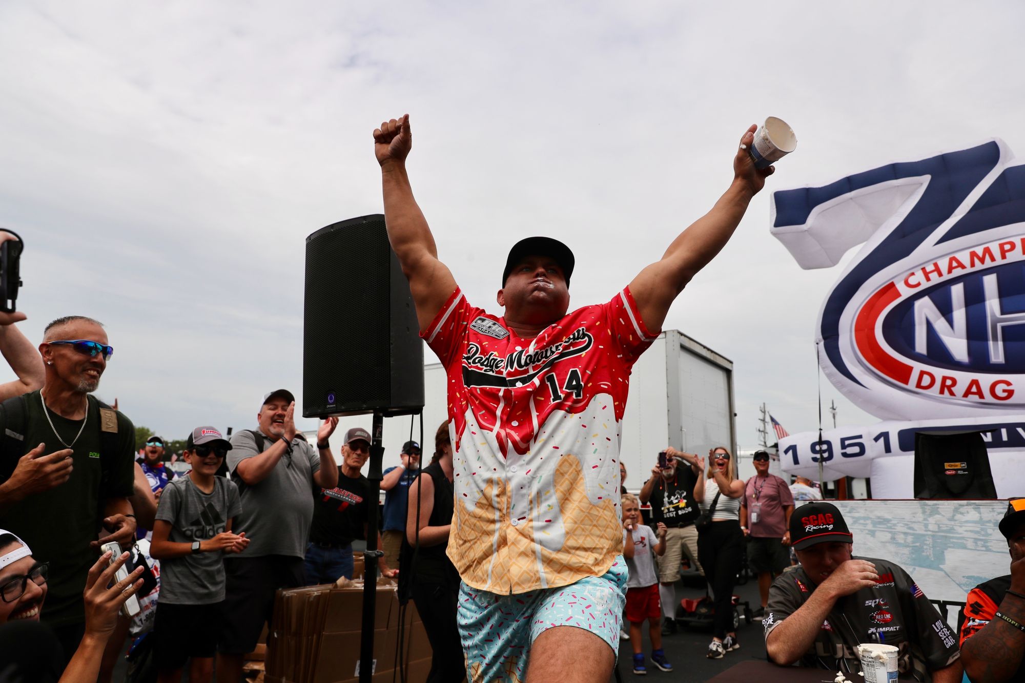 Matt Hagan celebrates winning the Summit Motorsports Park ice cream eating contest at the NHRA Norwalk Nationals