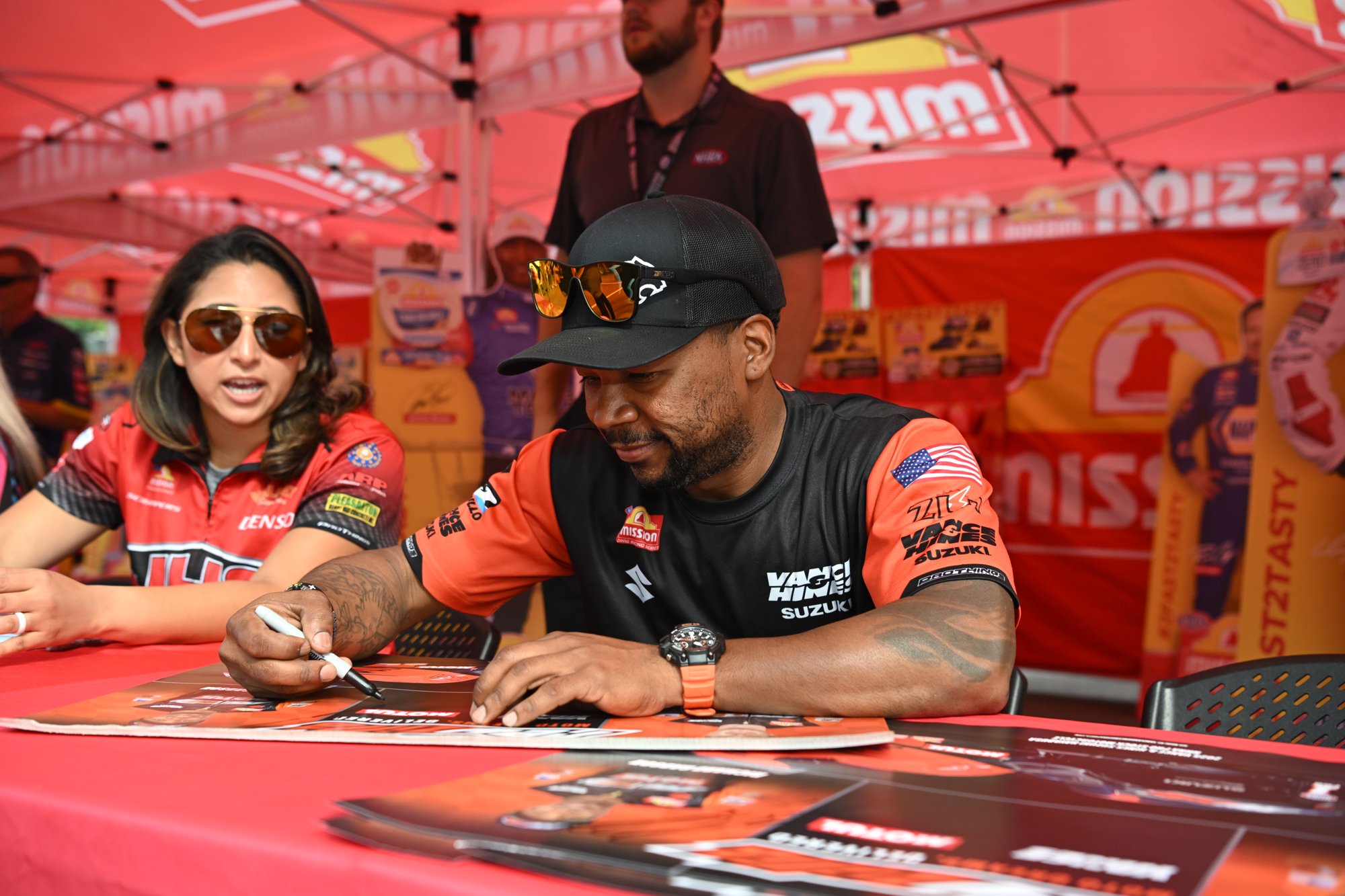 Richard Gadson and Jianna Evaristo sign autographs at the Mission Foods display at Bristol Dragway during the 2026 Super Grip NHRA Thunder Valley Nationals.