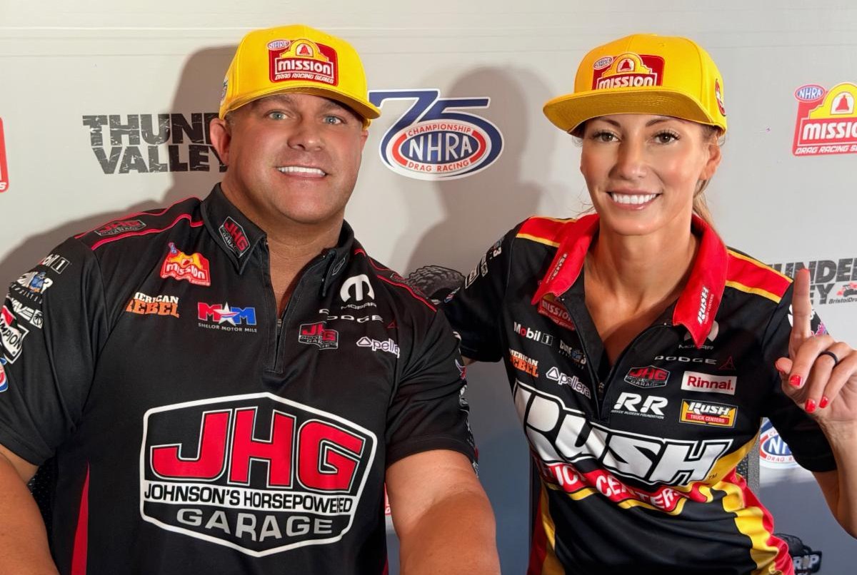 Matt Hagan and Leah Pruett pose with their Mission Foods No. 1 qualifier hats at the 2026 Super Grip NHRA Thunder Valley Nationals at Bristol Dragway.