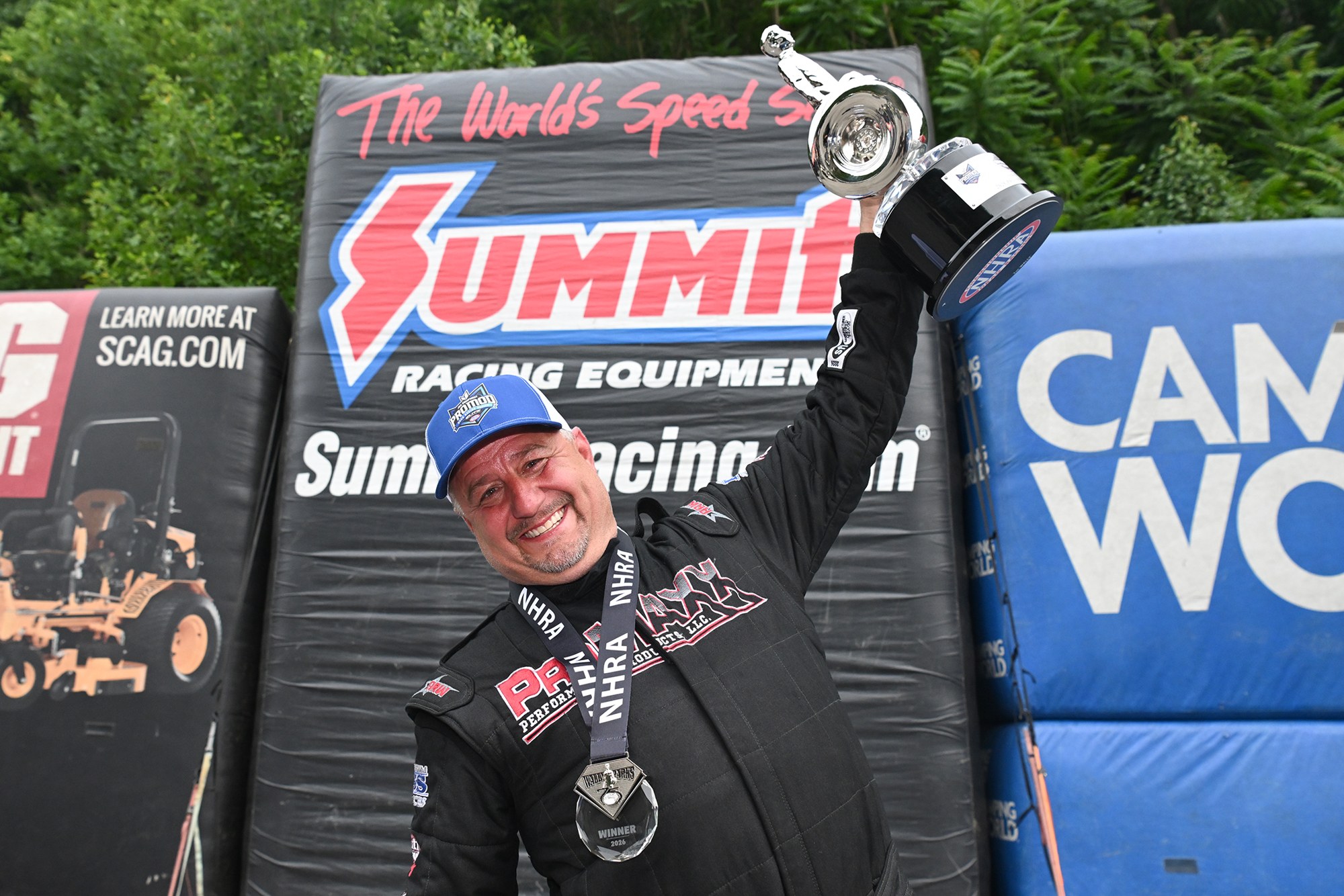 Jason Collins hoists the Pro Modified Wally at the 2026 Super Grip NHRA Thunder Valley Nationals at Bristol Dragway.