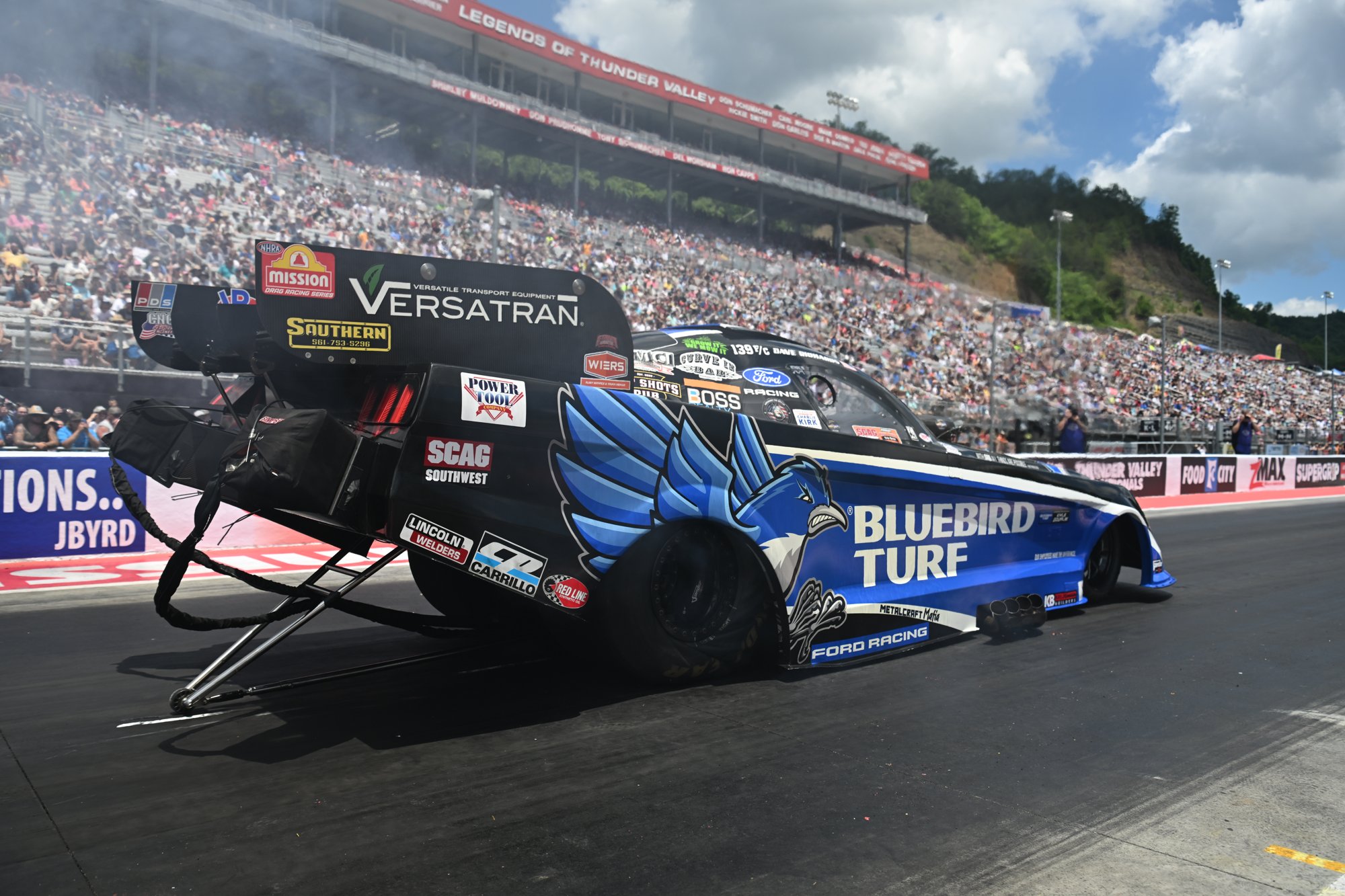 Spencer Hyde's Bluebird Turf Funny Car carries the front wheels off the line at Bristol Dragway during the 2026 Super Grip NHRA Thunder Valley Nationals.