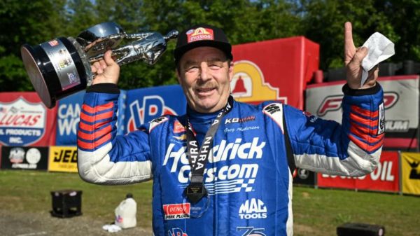 Greg Anderson, six-time Pro Stock world champion and 2026 points leader, celebrates with a Wally