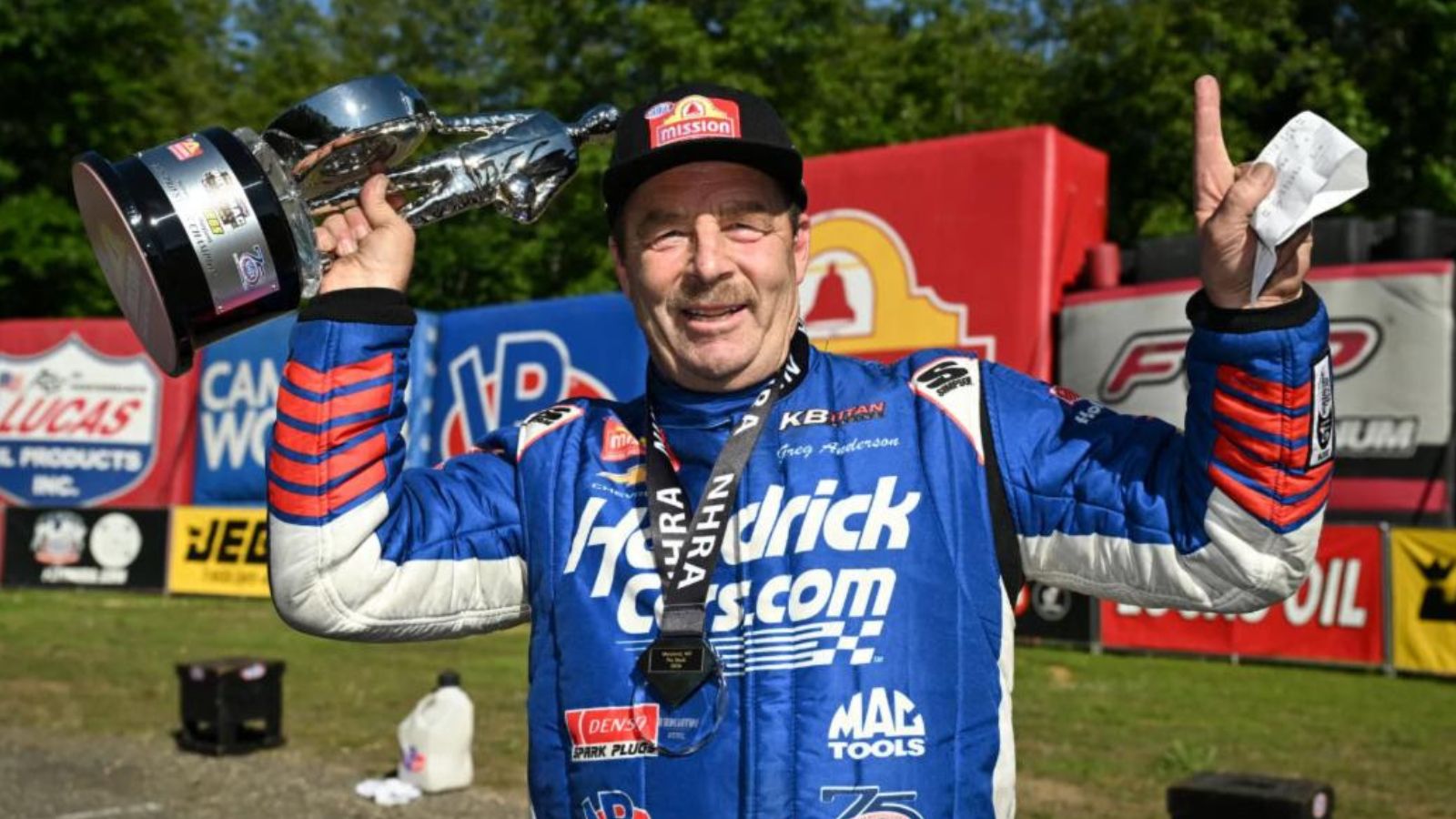 Greg Anderson, six-time Pro Stock world champion and 2026 points leader, celebrates with a Wally