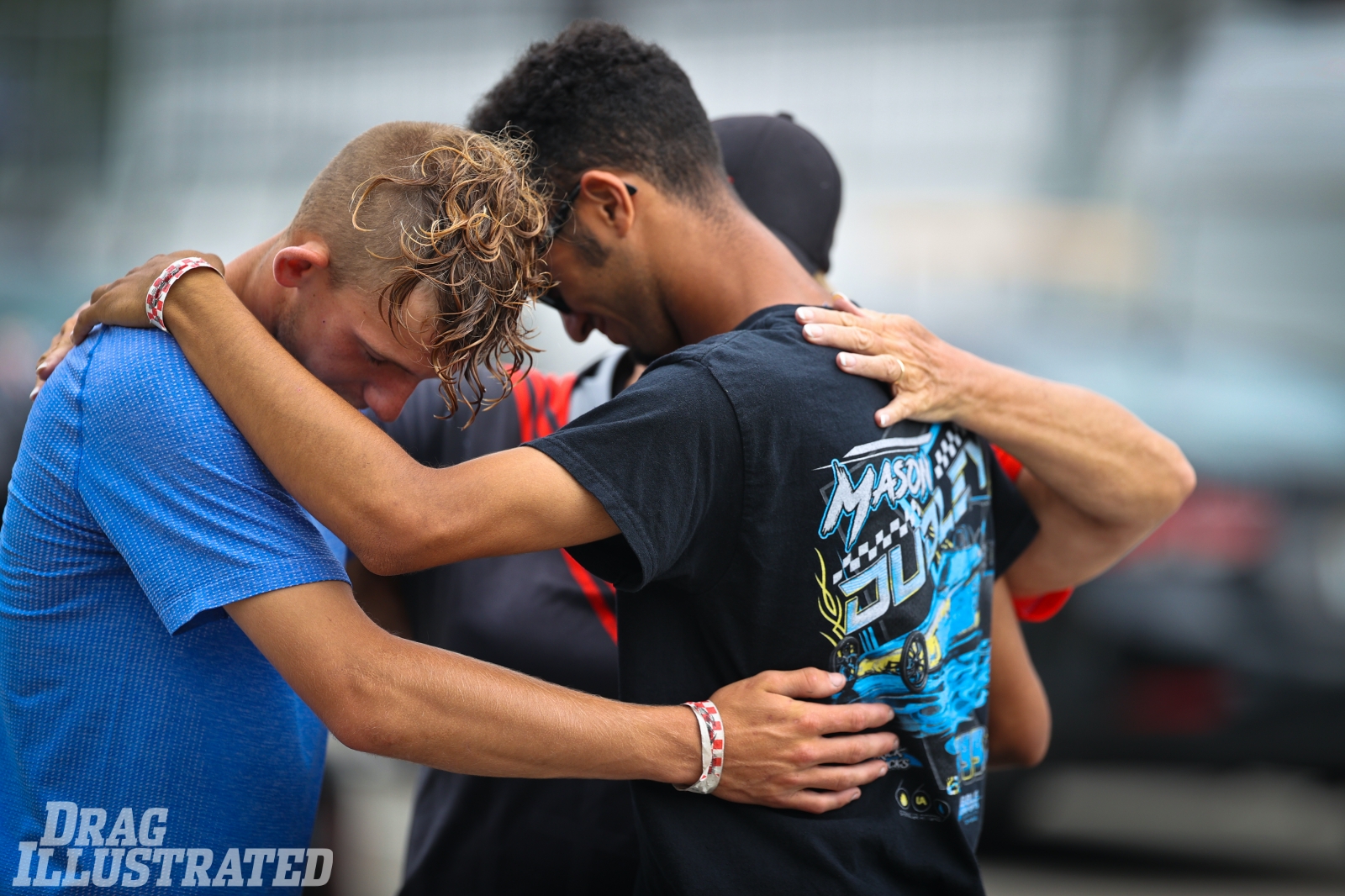 Competitors gather for a prayer circle before Thursday racing at Maryland International Raceway