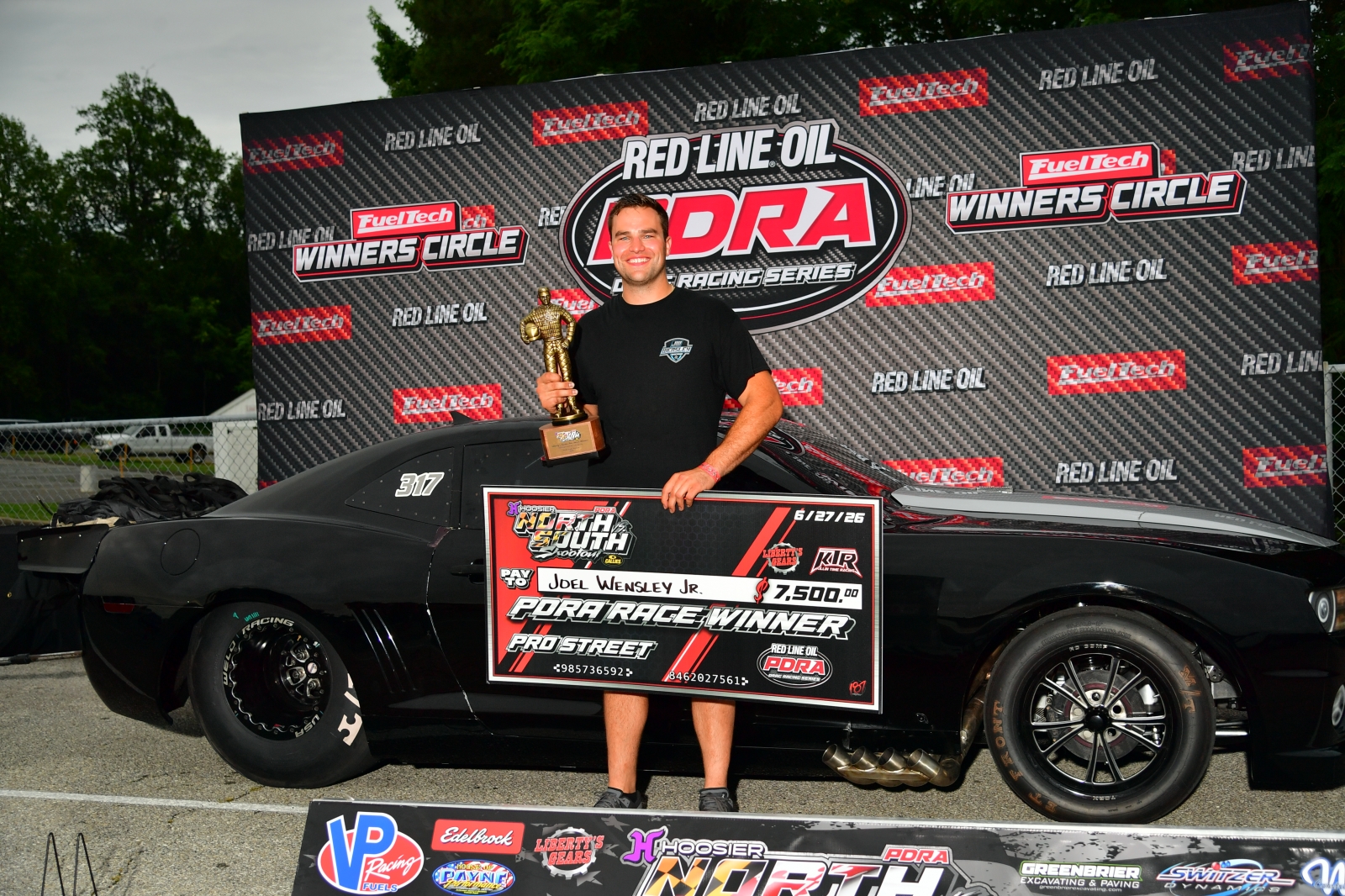 Joel Wensley Jr. in the PDRA winner's circle with the Pro Street trophy