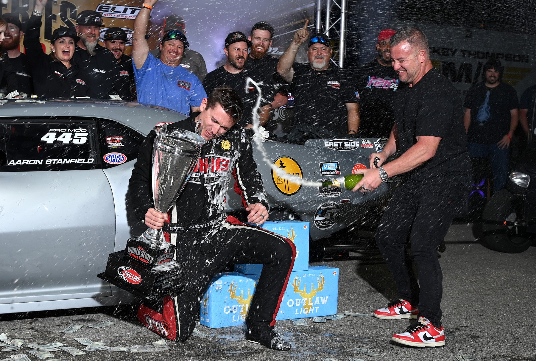 Aaron Stanfield is doused with champagne by WSOPM promoter Wes Buck after winning the 2026 World Series of Pro Mod.
