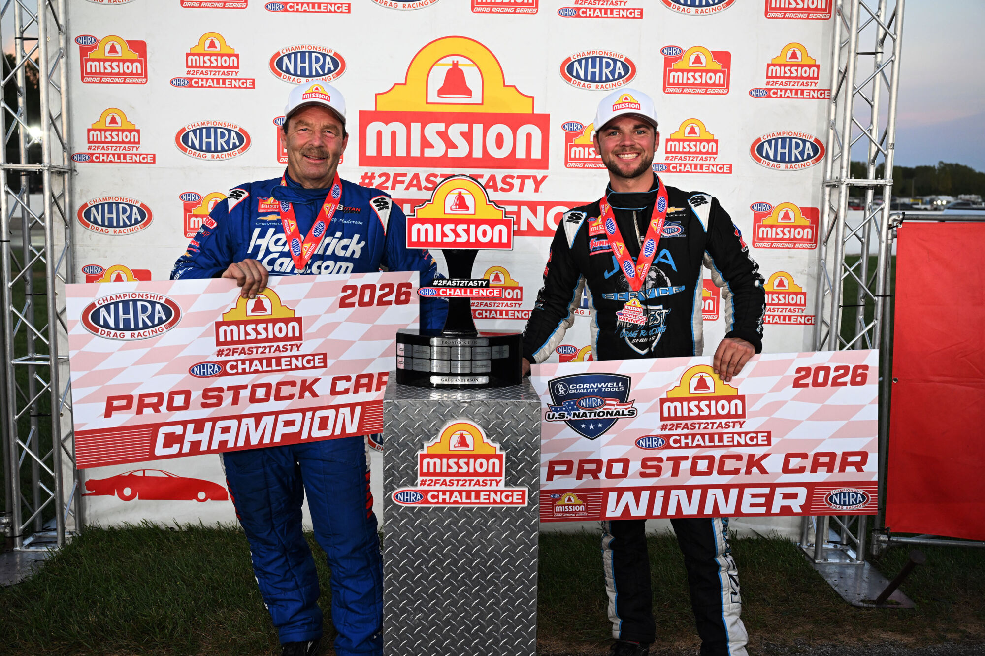 Greg Anderson and Cody Anderson in the Mission 2Fast2Tasty Challenge winners circle at the 2026 NHRA U.S. Nationals with the Pro Stock trophy