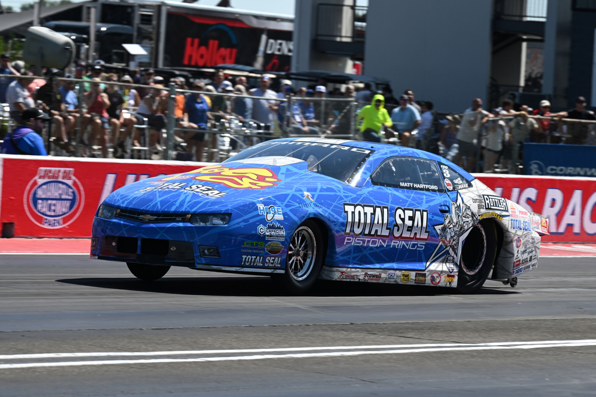 Matt Hartford lifts the front wheels of the Total Seal Piston Rings Chevrolet Camaro off the starting line at Indianapolis