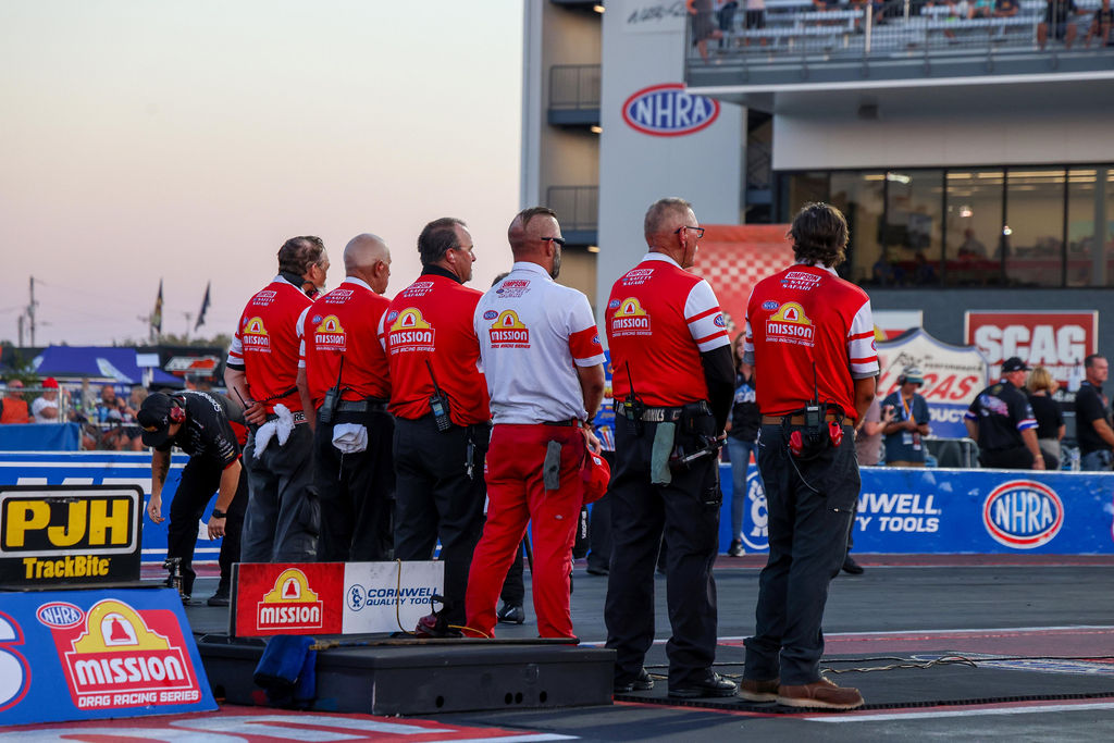 NHRA officials on the starting line at dusk during the 2026 U.S. Nationals