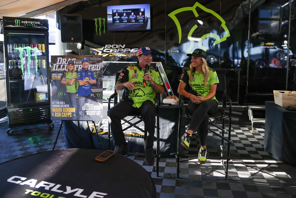 Ron Capps and Maddi Gordon with the Drag Illustrated Power 100 issue at the Carlyle Tools hauler, 2026 NHRA U.S. Nationals
