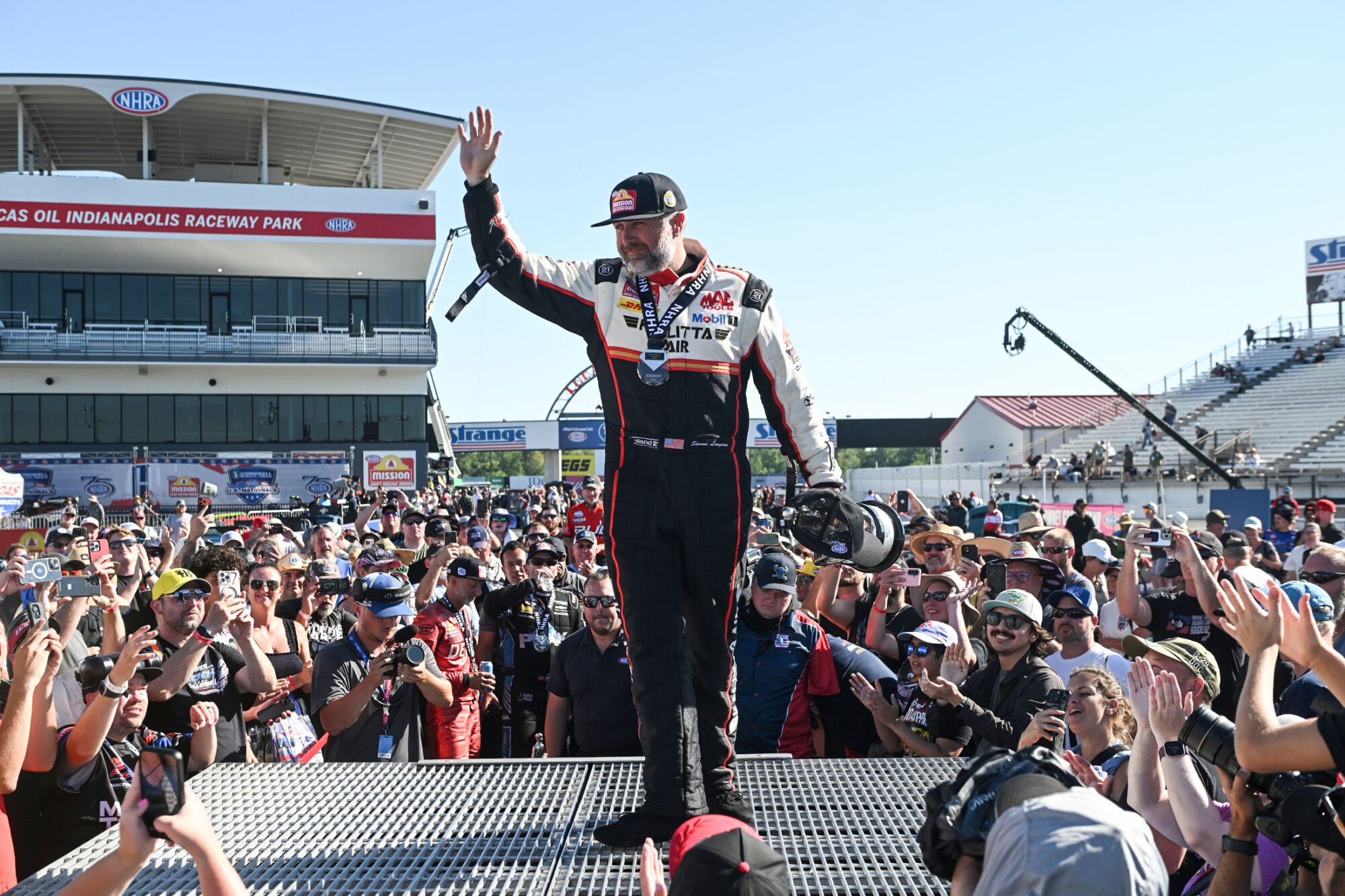 Shawn Langdon waves to the crowd from the winners stand at Lucas Oil Indianapolis Raceway Park after winning the U.S. Nationals