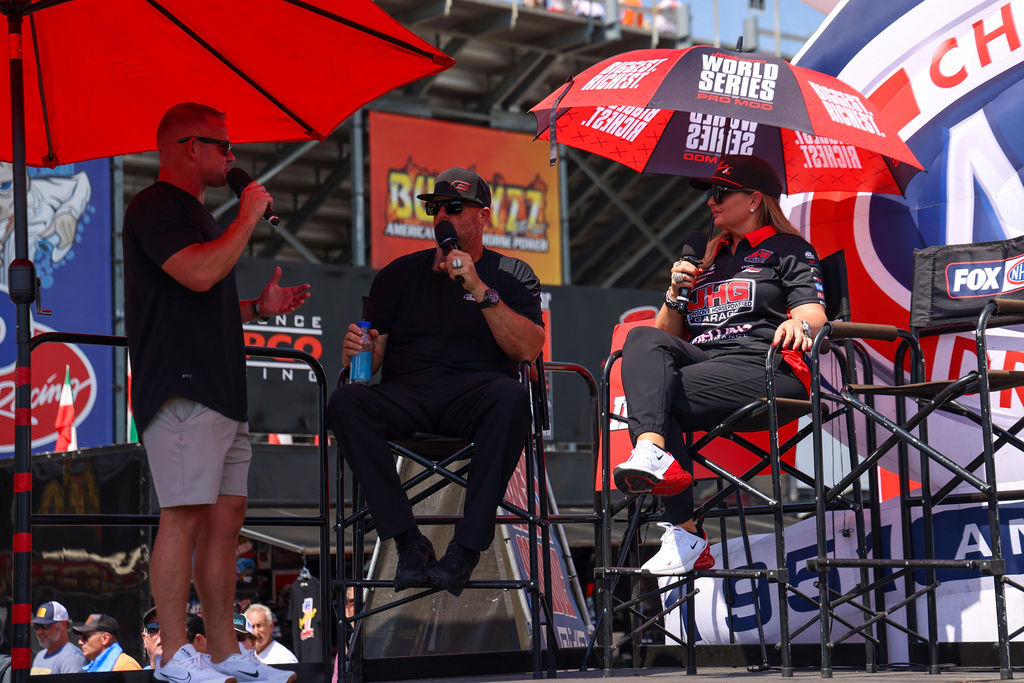 Wes Buck interviewing guests on stage at the 2026 NHRA U.S. Nationals