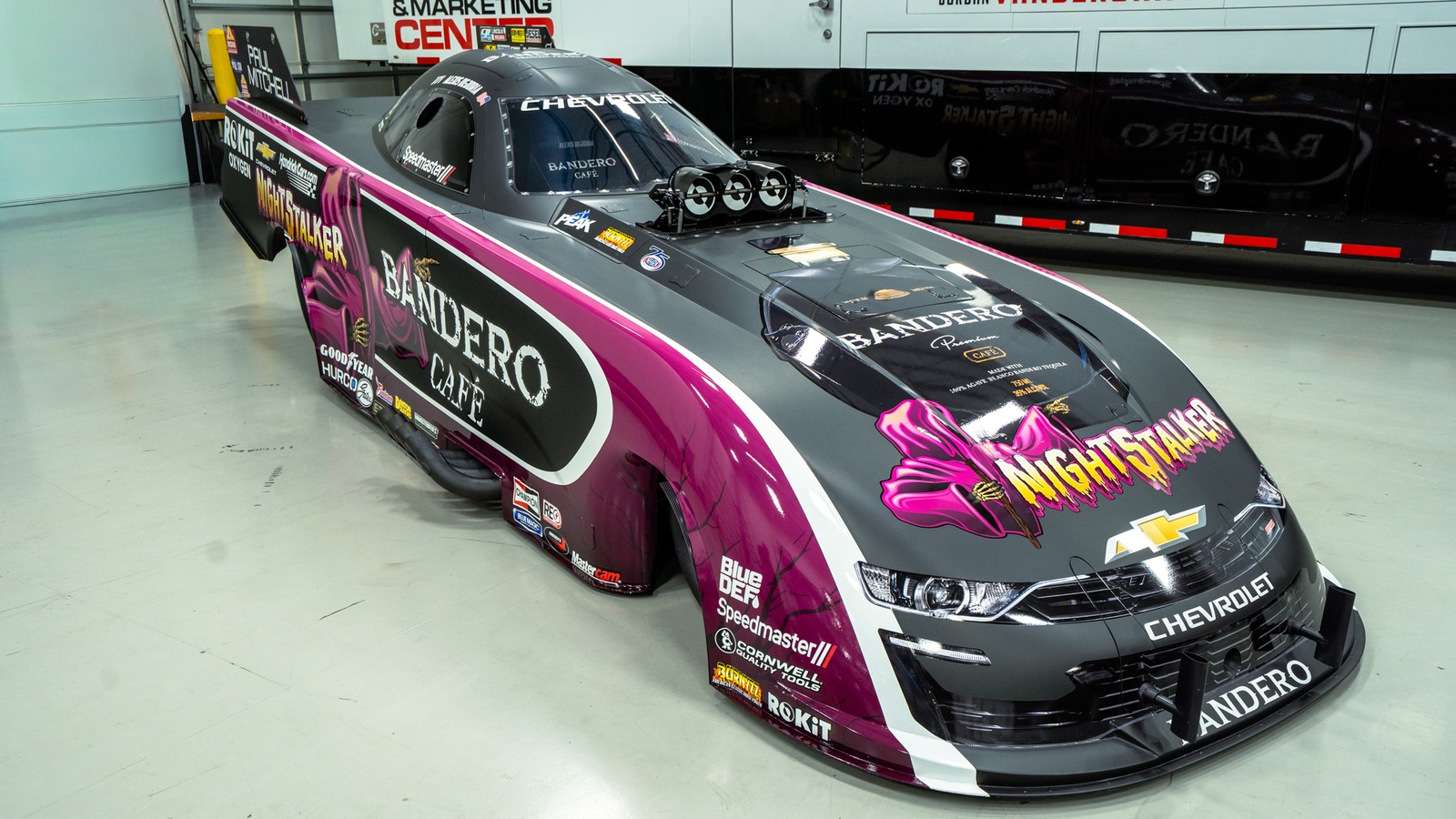 Alexis DeJoria Bandero Cafe Chevrolet SS Funny Car in the purple and grey John Force Night Stalker tribute livery