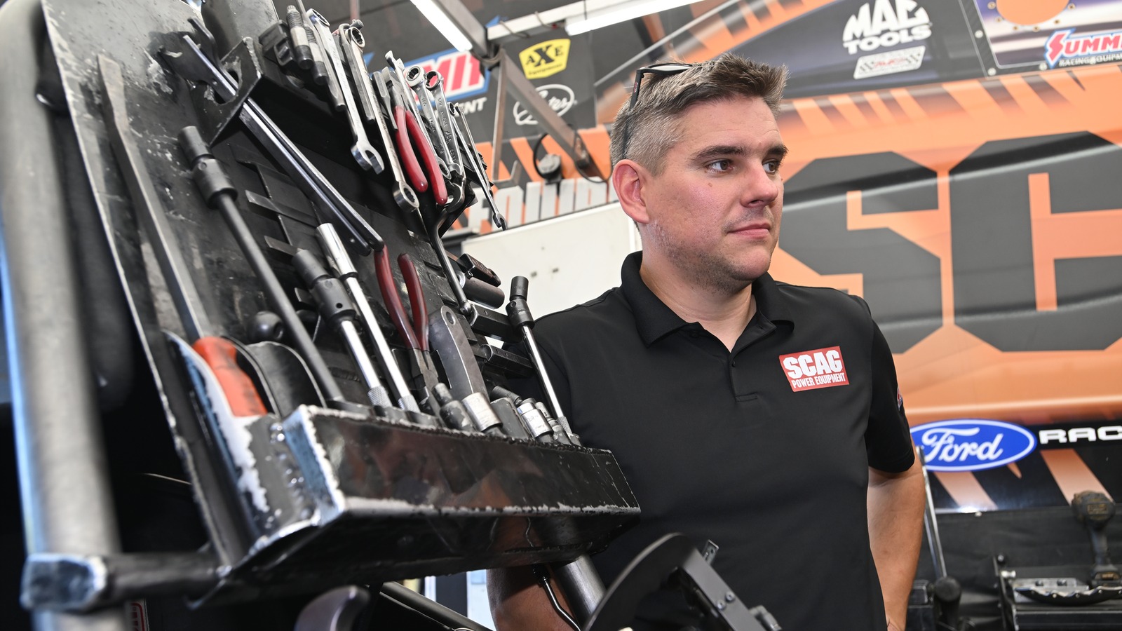 Daniel Wilkerson stands at the toolbox in the SCAG Racing pit at Indianapolis before warming up the Funny Car
