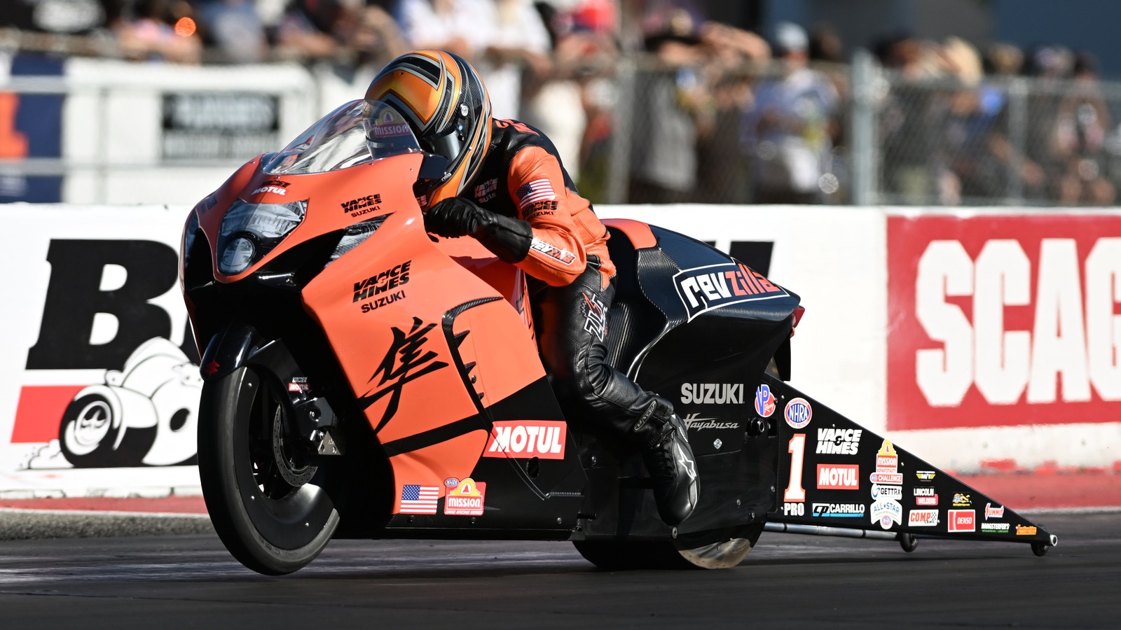 Gaige Herrera tucked in on the orange and black Vance and Hines Suzuki Hayabusa Pro Stock Motorcycle at the NHRA U.S. Nationals