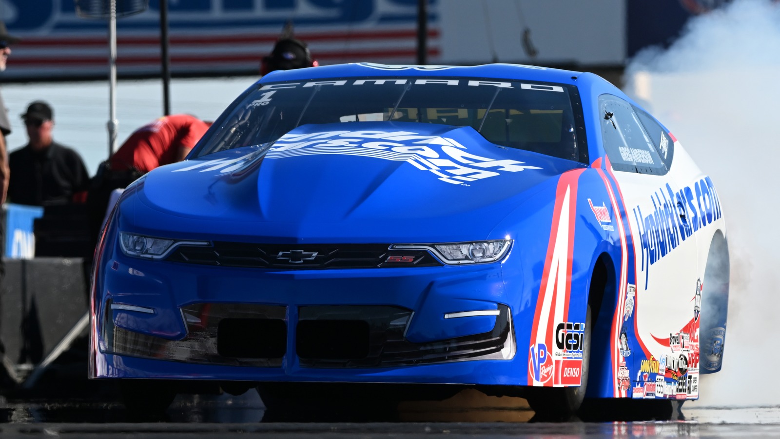 Greg Anderson does a burnout in his blue HendrickCars.com Chevrolet Camaro Pro Stock car at the NHRA U.S. Nationals