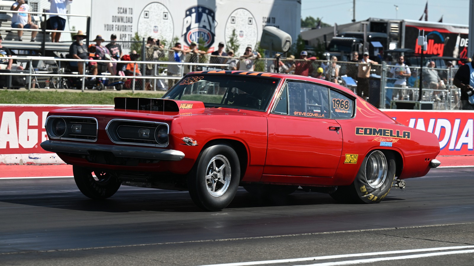 Steve Comella pulls the front wheels off the ground in his red 1968 Plymouth Barracuda during the Sox and Martin Hemi Challenge at Indianapolis