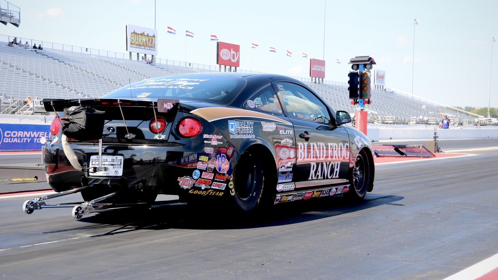 Taylor Chomiski stages his black Blind Frog Ranch Chevrolet Cobalt Competition Eliminator car at Lucas Oil Indianapolis Raceway Park