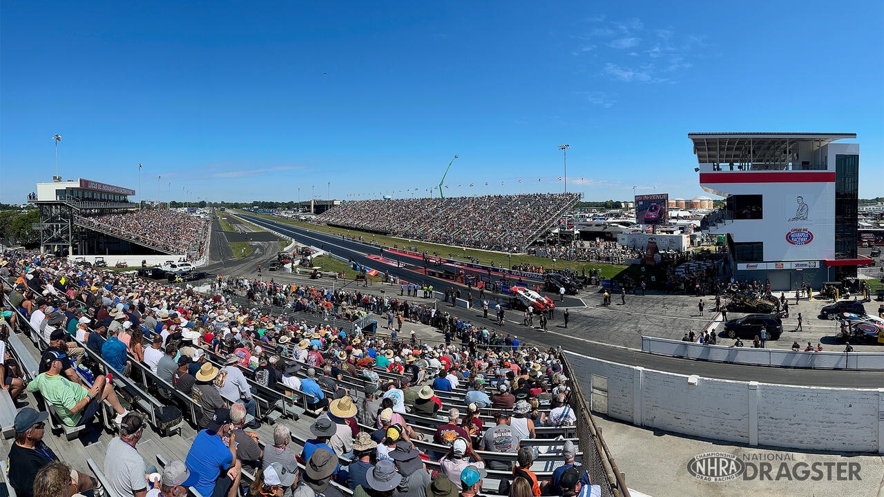Wide view of packed grandstands on both sides of the dragstrip at Lucas Oil Indianapolis Raceway Park during the NHRA U.S. Nationals