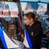 Aaron Stanfield sits in Leah Pruett's Tony Stewart Racing Top Fuel dragster as Pruett looks on at Texas Motorplex