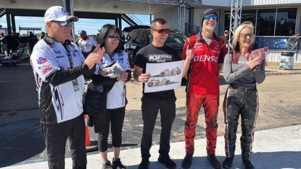 Joey Gladstone holds a rendering of his 2027 RAD Torque Systems Matt Smith Racing Buell Pro Stock Motorcycle