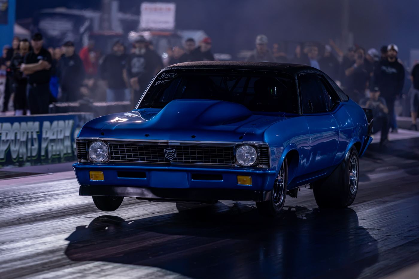 Blue Chevy Nova staged under the lights during Friday qualifying at No Mercy 17