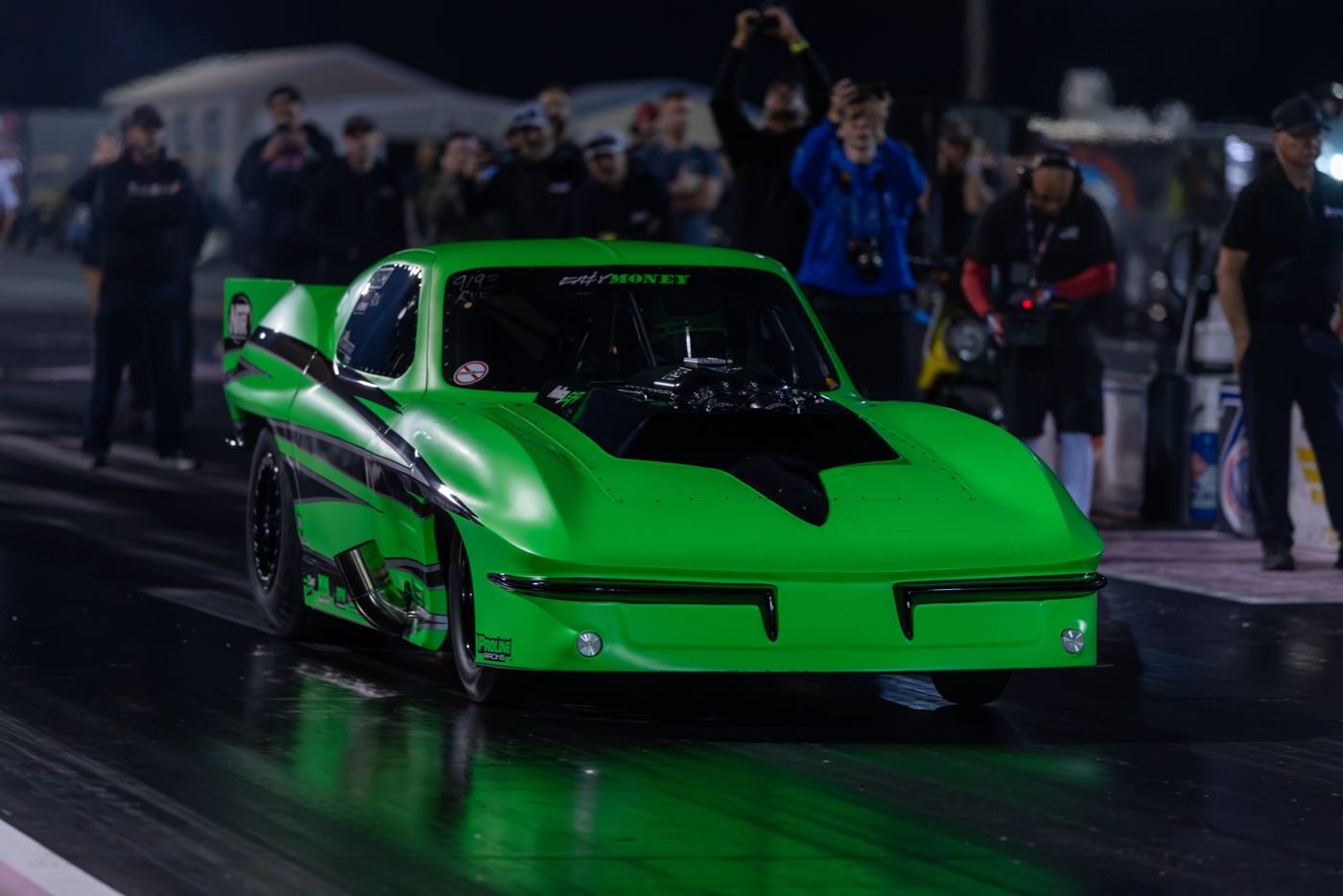 Lime green fourth-generation Camaro staged with the crowd behind the wall at No Mercy 17