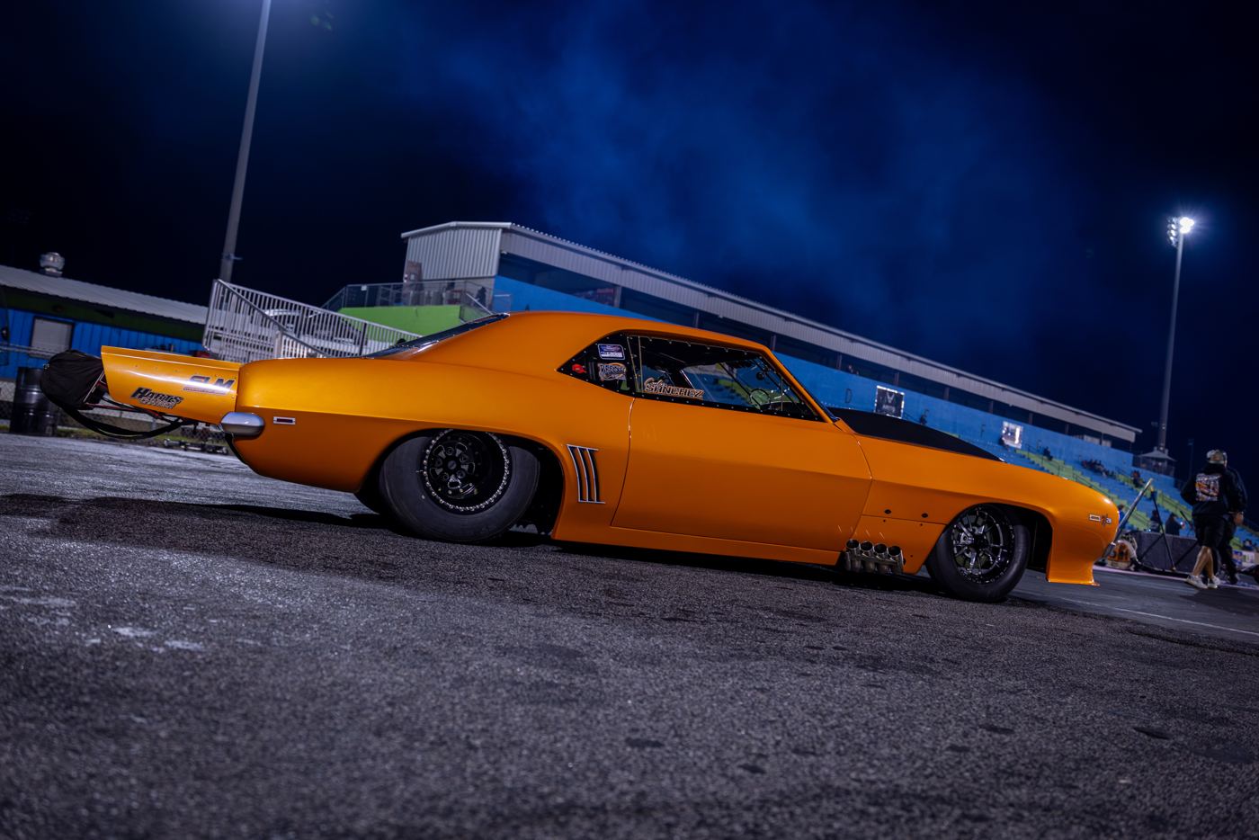 Orange 1969 Camaro in profile on the SGMP starting line in daylight