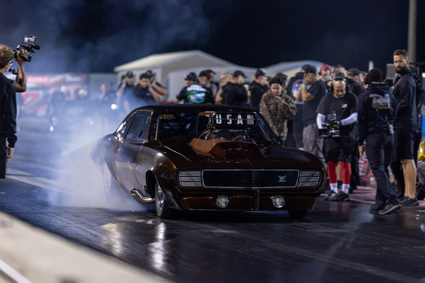 Brown 1969 Camaro in a smoky burnout with the crowd behind it at No Mercy 17