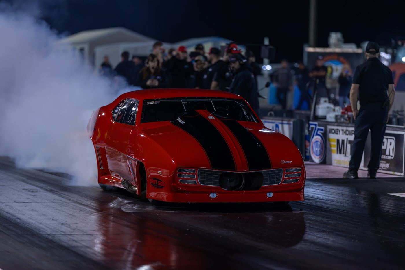 Ken Quartuccio's red and black Pro Line-powered 1969 Camaro in the water box under the lights at No Mercy 17, Radial vs. the World